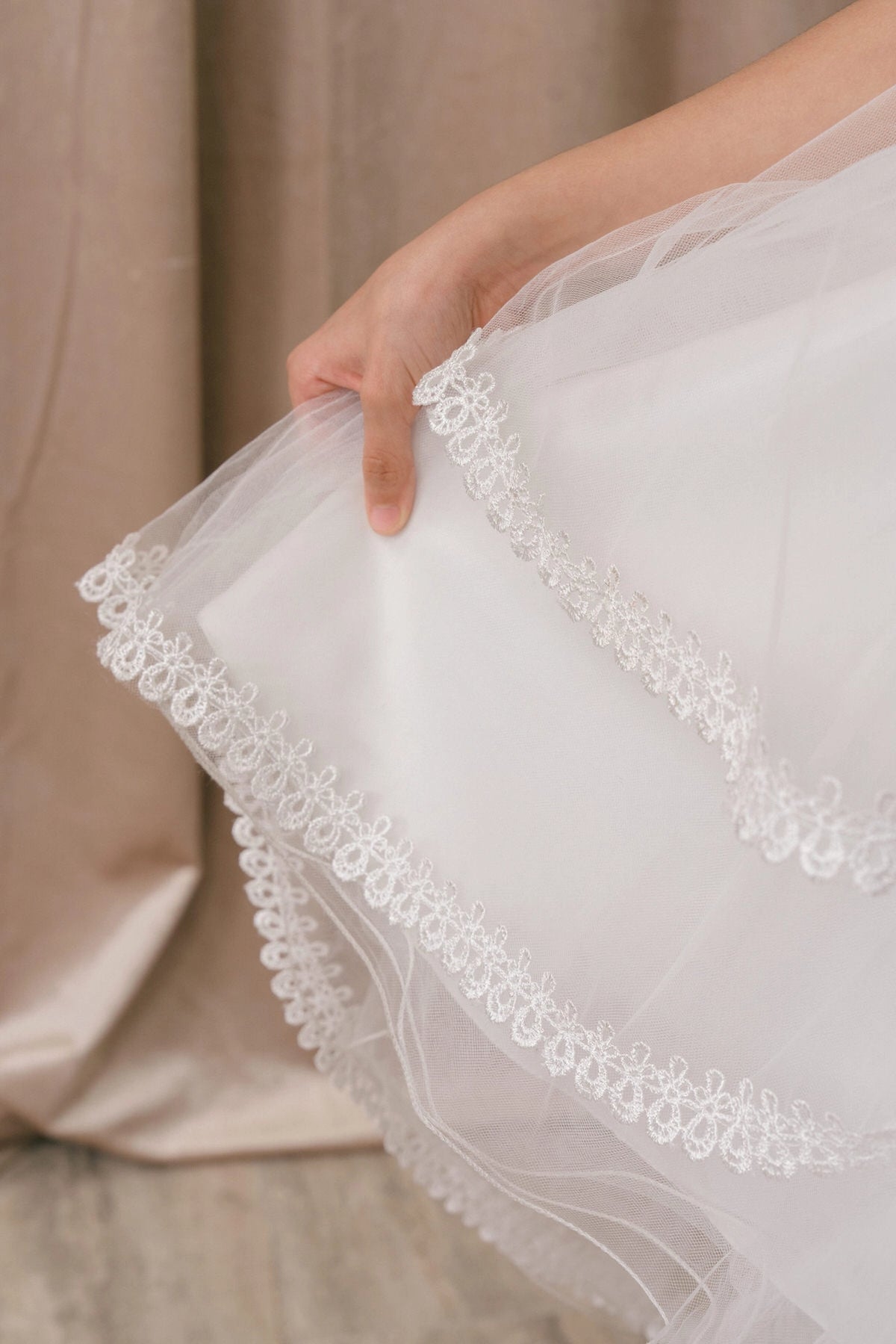 Notice the scalloped lace trim along the tulle tier on this White flower girl dress.