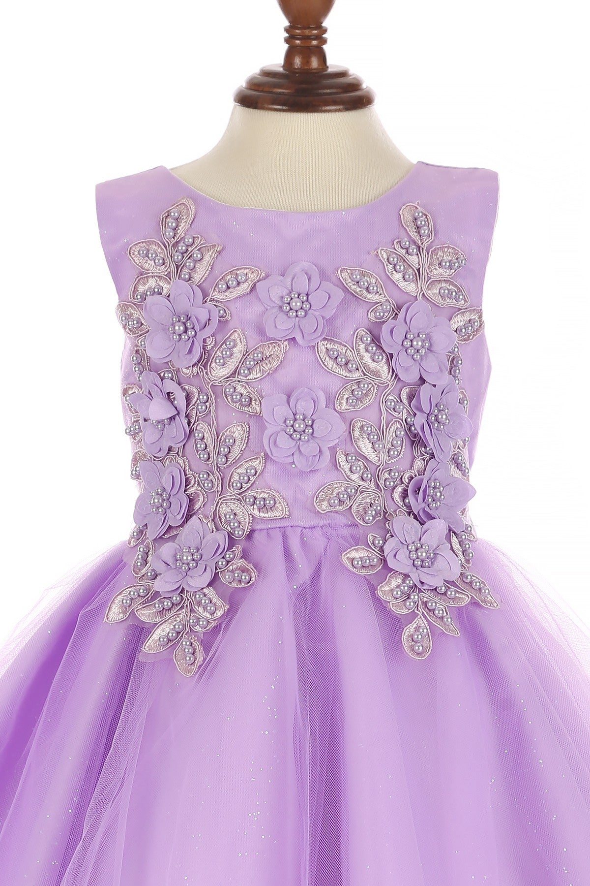 Close-up front view of lilac flower girl dress showing beadwork and floral embroidery detail.