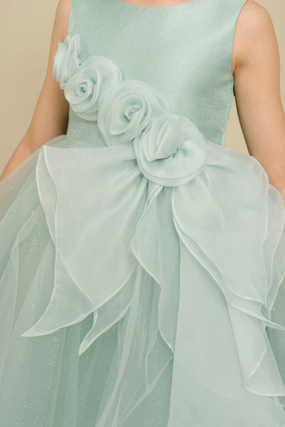 Details of the Sage flower girl dress include fabric roses above the draped ruffle.