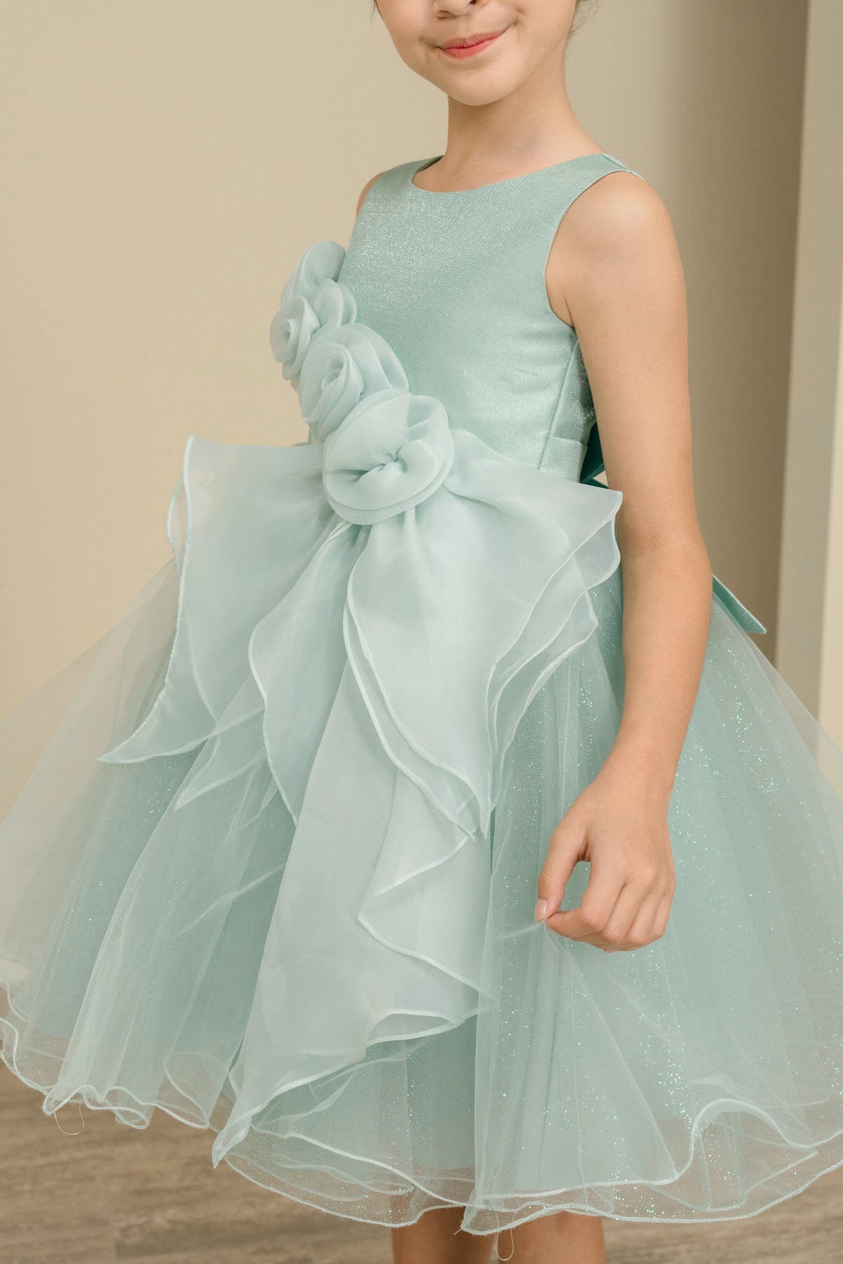 Visible on this Sage flower girl dress: dimensional waist flowers on a sleeveless bodice.