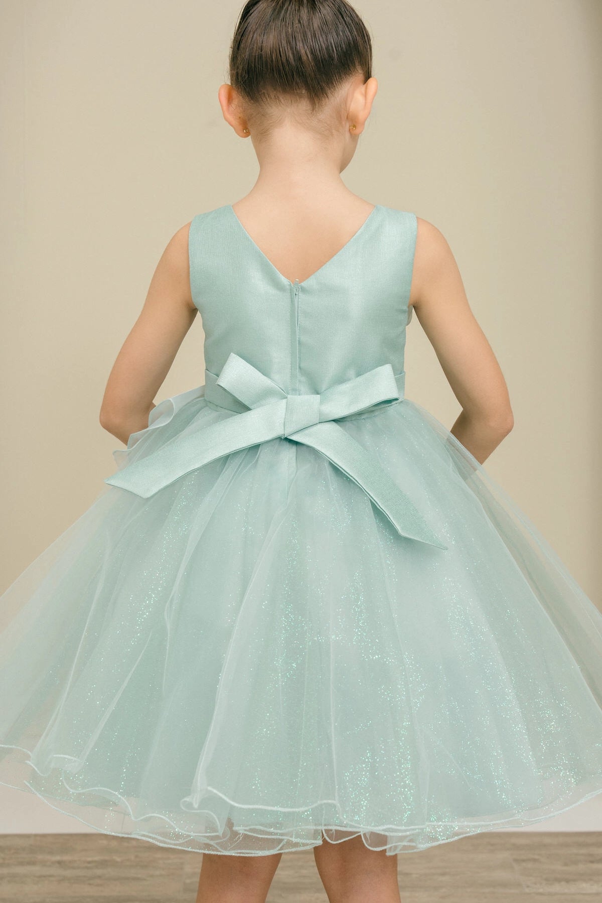 Notice the satin bow below the V-shaped back on this Sage flower girl dress.