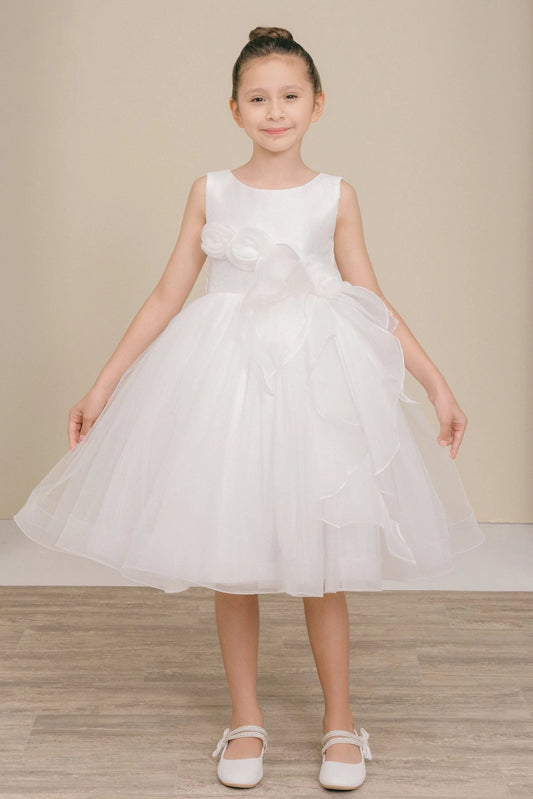 White flower girl dress features floral waist above cascading skirt ruffles.