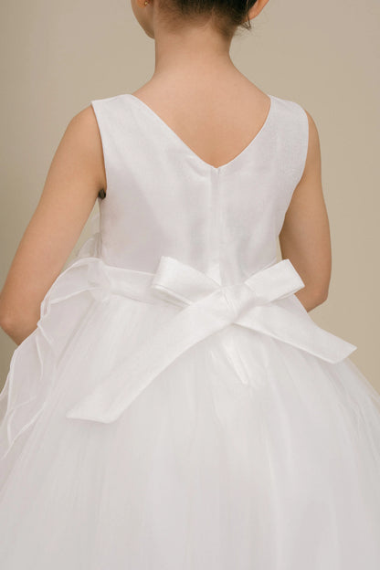 Details of the White flower girl dress include V neckline and satin bow at the back.