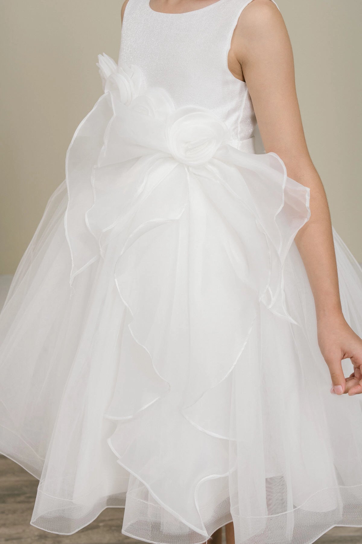Notice the cascading ruffle below the floral waist on this White flower girl dress.