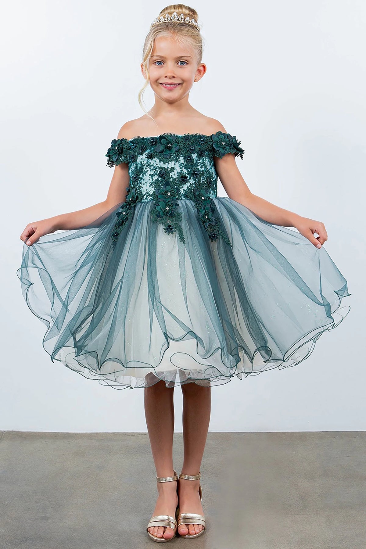 A green off-shoulder flower girl dress with floral details.