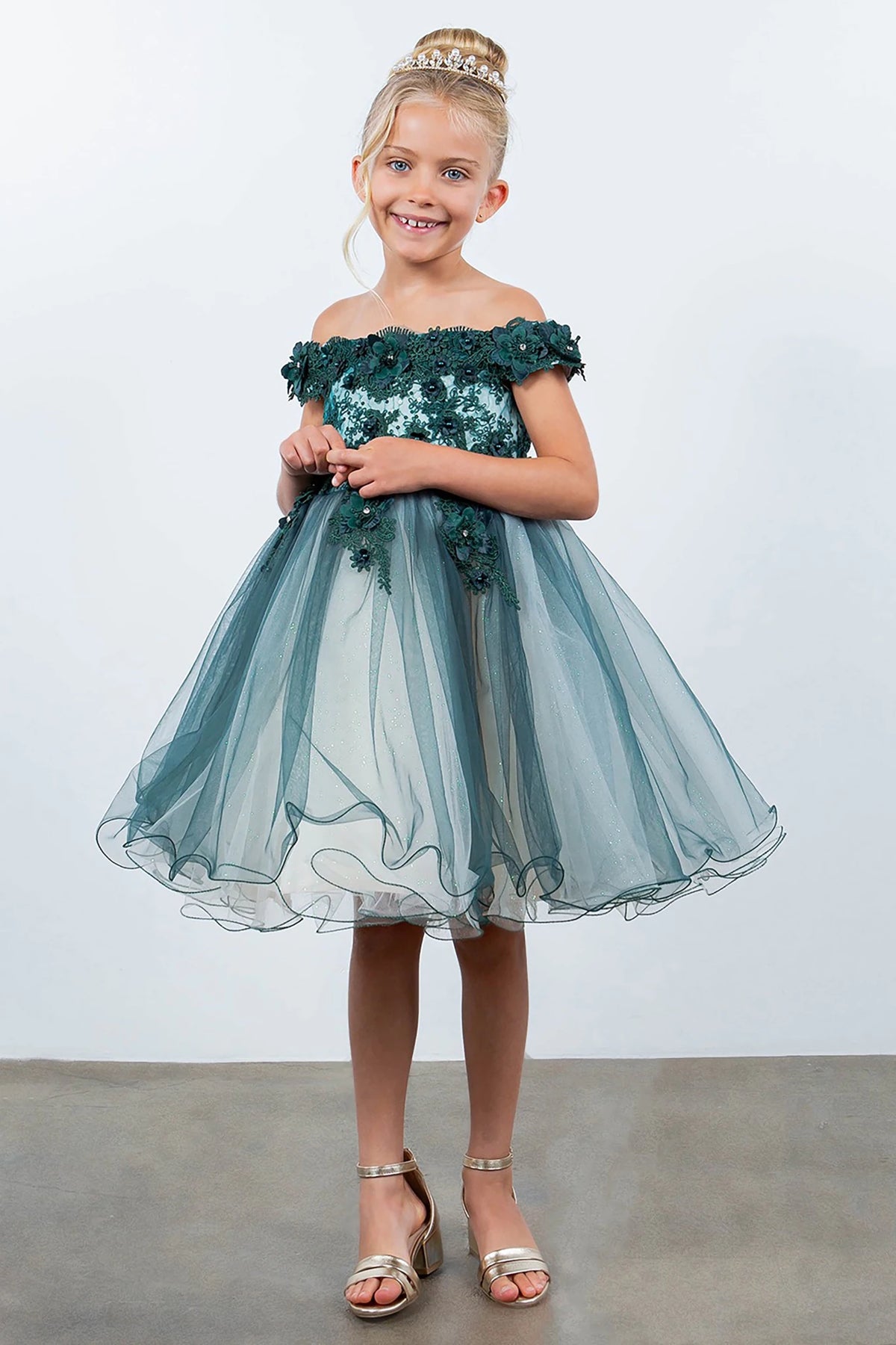 A green off-shoulder flower girl dress with floral details.