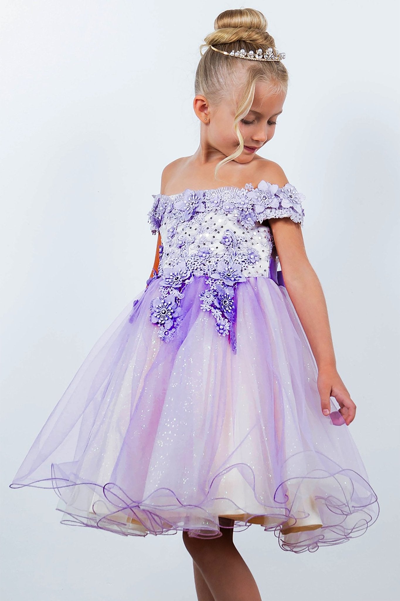A lilac off-shoulder flower girl dress with floral details.