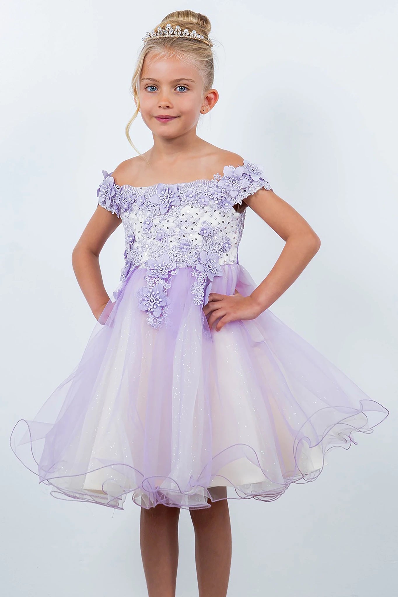 A lilac off-shoulder flower girl dress with floral embellishments.