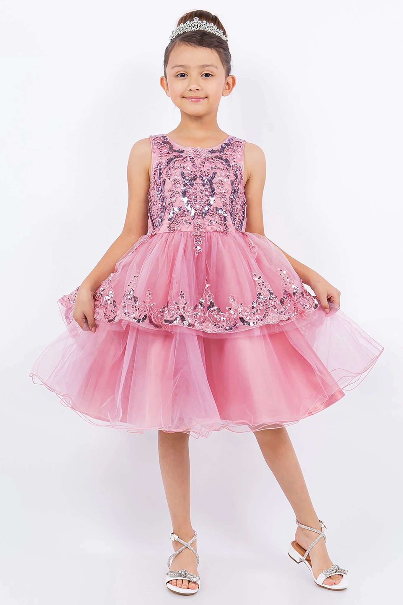A pink sequined flower girl dress.