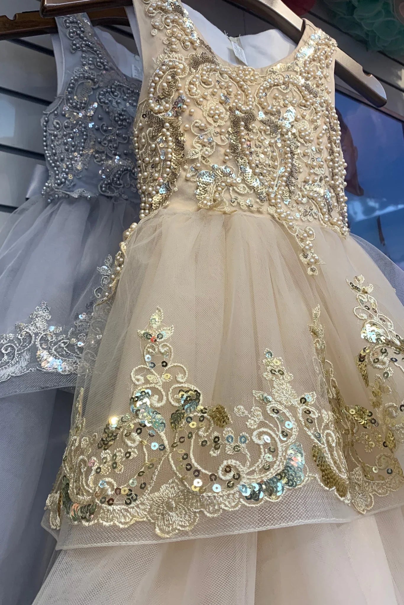 Decorative flower girl dress with intricate beadwork.