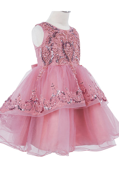Pink sequin dress on a mannequin against a white background