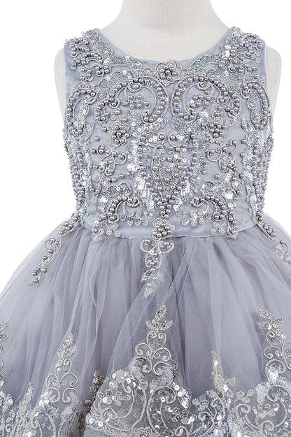 Gray dress with intricate silver beadwork on a mannequin