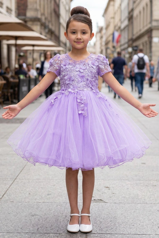Shown in a front view, the Lilac flower girl dress has floral cap sleeves and full tulle skirt with a wired hem.