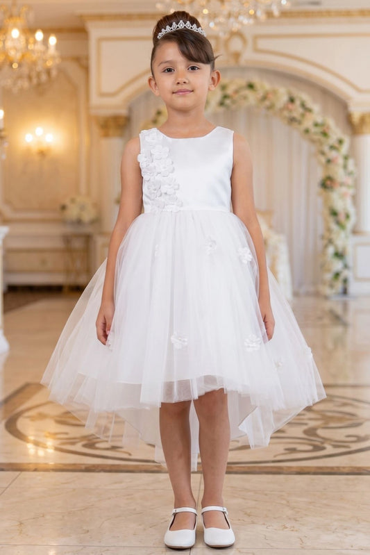 White flower girl dress features raised floral trim above the asymmetric skirt.