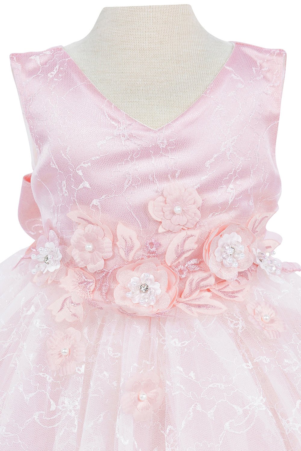 Close-up front view of pink flower girl dress showing beadwork and floral embroidery detail.