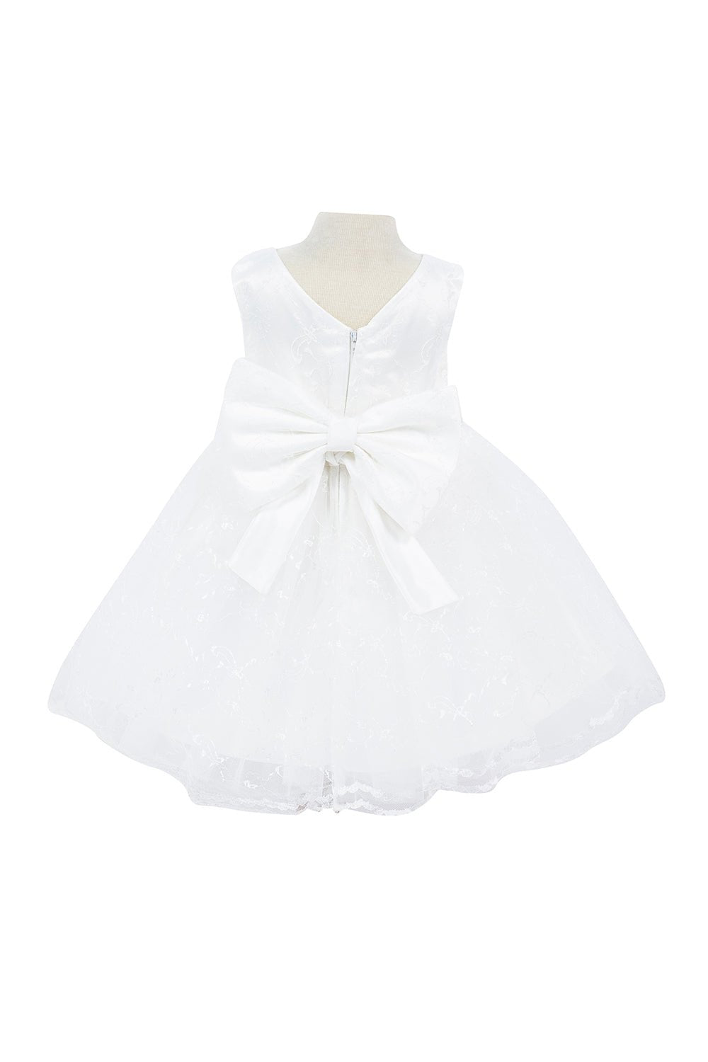 White flower girl dress back view highlighting flowing tulle skirt and elegant silhouette.