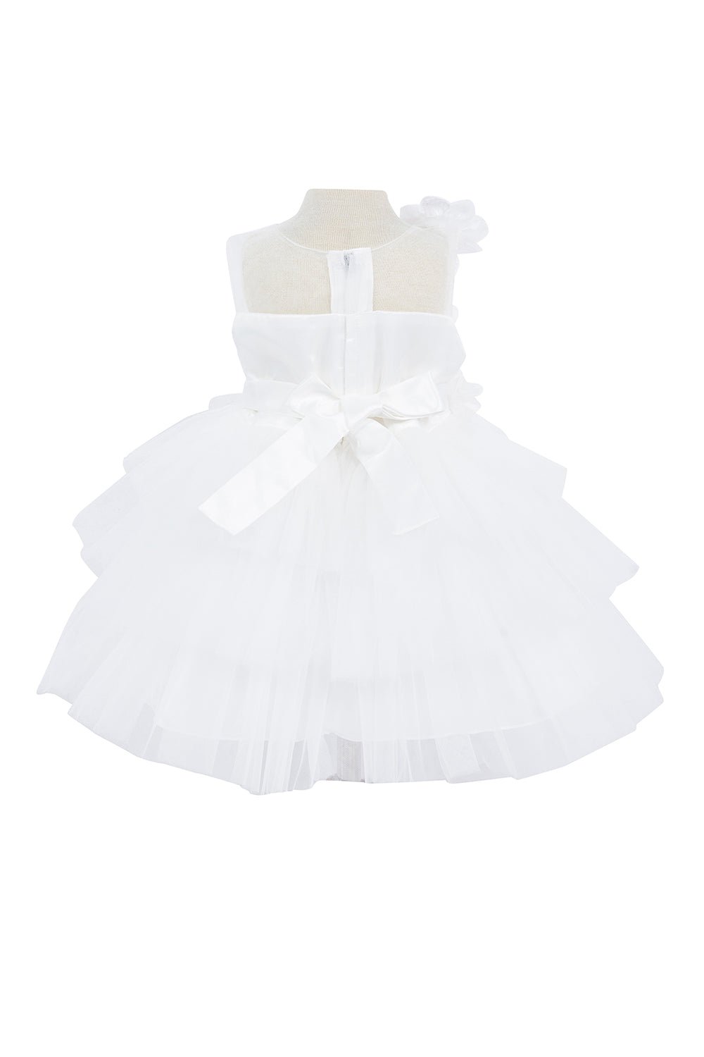Ivory flower girl dress back view highlighting voluminous tulle skirt and elegant silhouette.