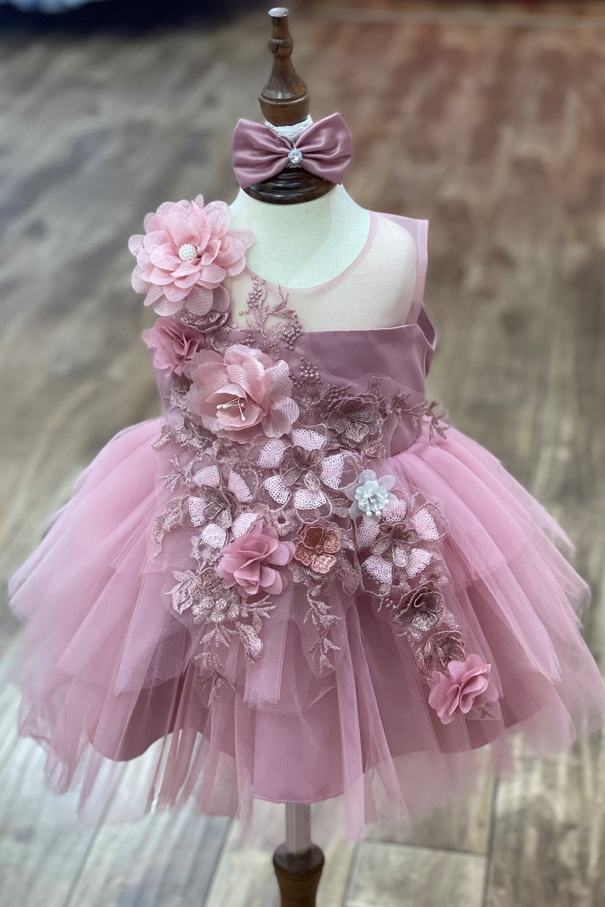 Mauve flower girl dress front view with embroidered bodice and layered tulle skirt.