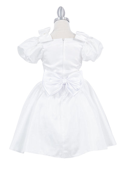 A Ivory flower girl dress showing back bow and zipper on the satin bodice.