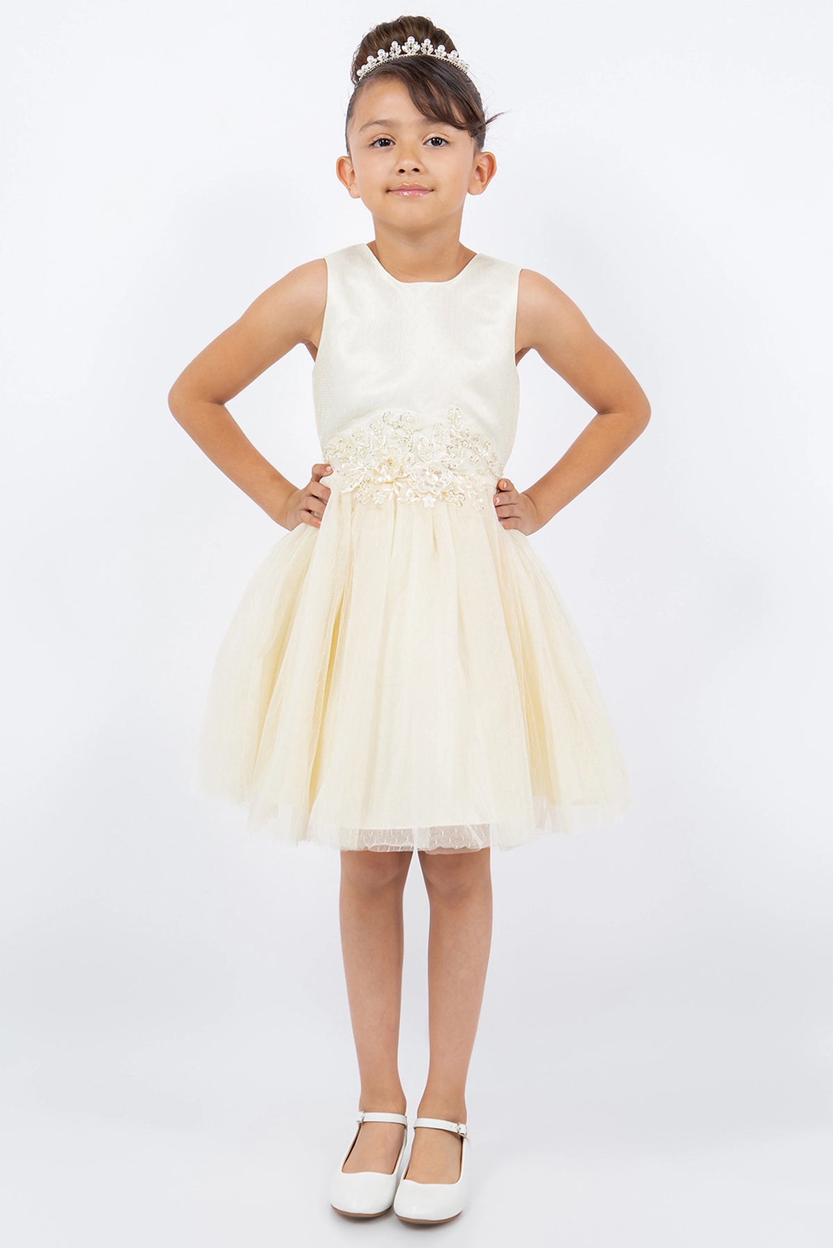 Champagne flower girl dress features flower appliques above a layered tulle skirt.
