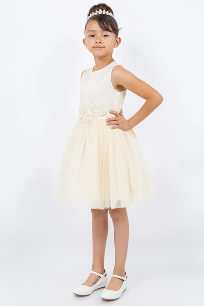 Details of the Champagne flower girl dress include flowers at the waist above the flared skirt.