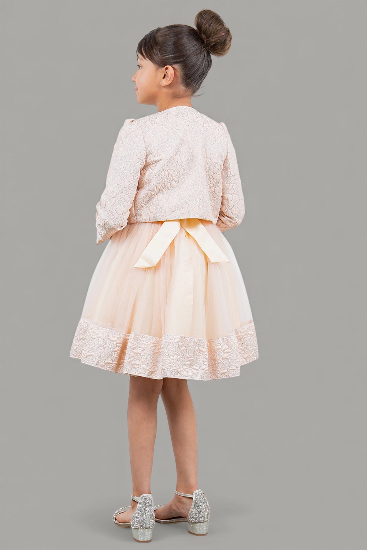 Finished details of a cropped matching jacket and waist bow distinguish the Pink kids party dress.
