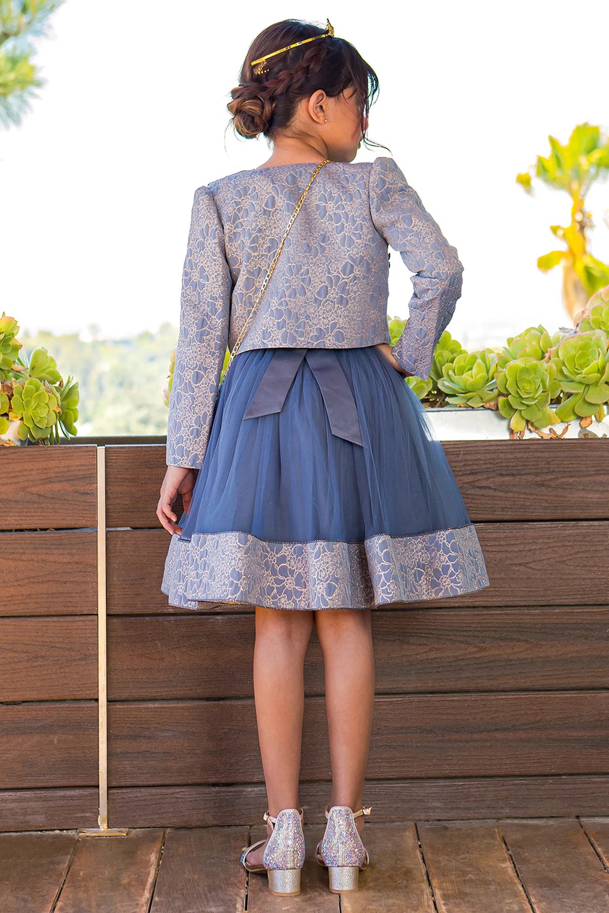 Finished details of a cropped matching jacket and waist bow distinguish the Royal Blue kids party dress.