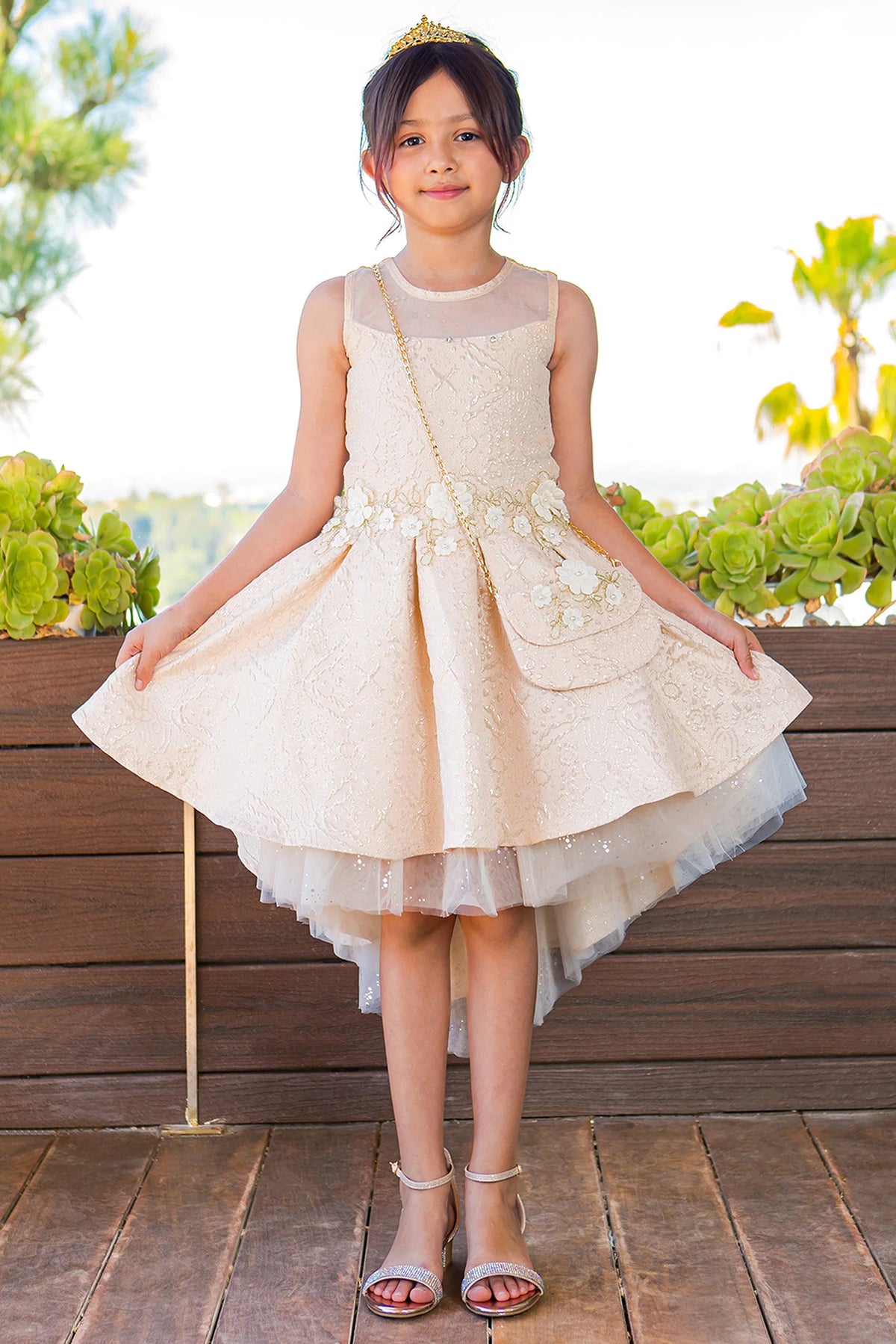 Showcasing with a high-low jacquard skirt, this Champagne kids party dress displays elegant detail.
