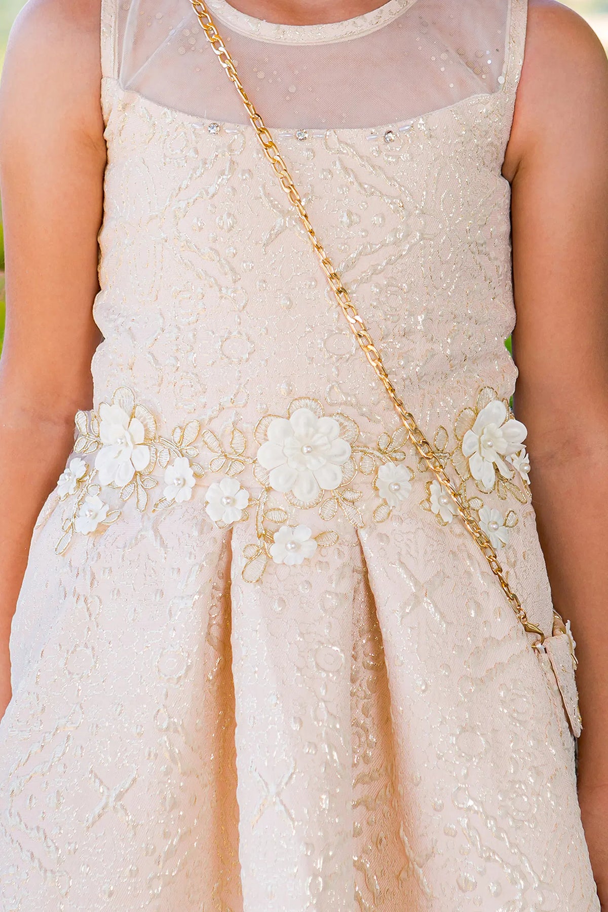 Detailed by a high-low jacquard skirt, the Champagne kids party dress reveals its construction.