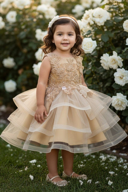 Kid Wearing Gold Flower Girl Dress Front View With Layered Skirt And Oversized Bow Detail