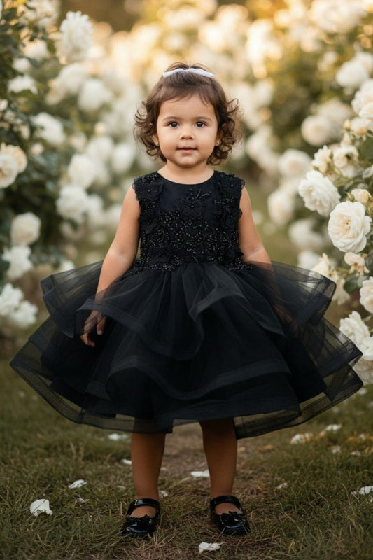 Black flower girl Dress Front View With Layered Skirt And Oversized Bow Detail.