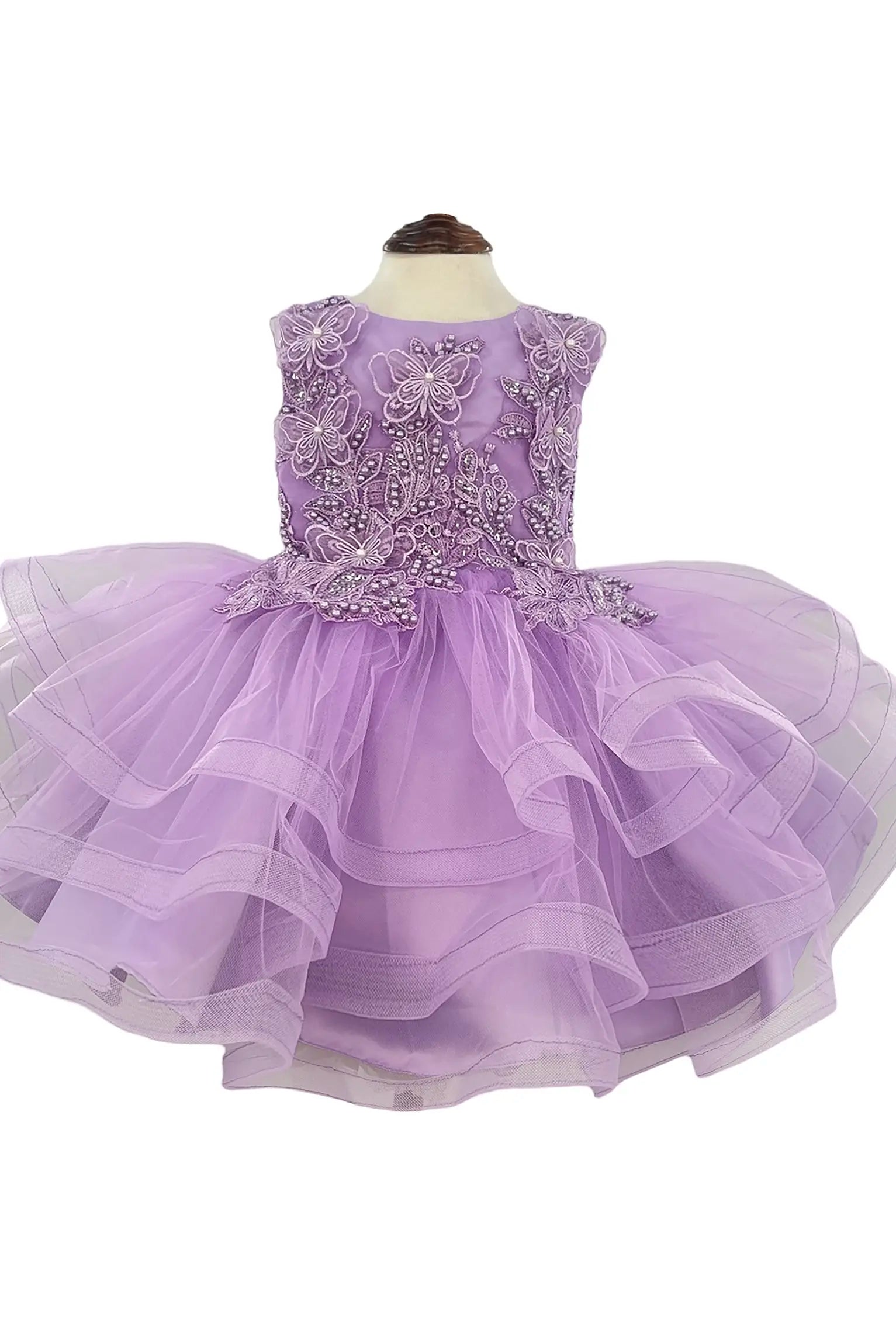 Lavender dress with beaded top and butterfly, floral appliques on a white background