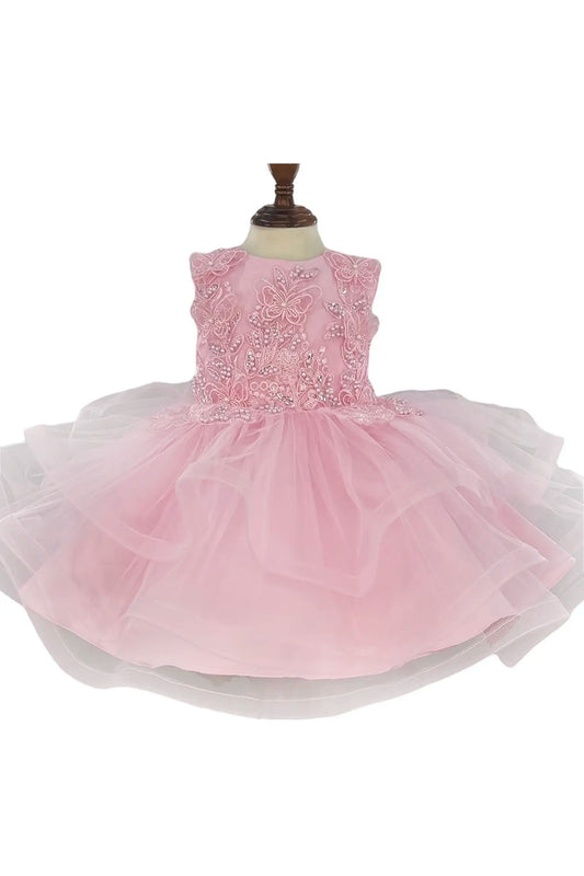 Pink dress with floral embellishments on a mannequin against a white background