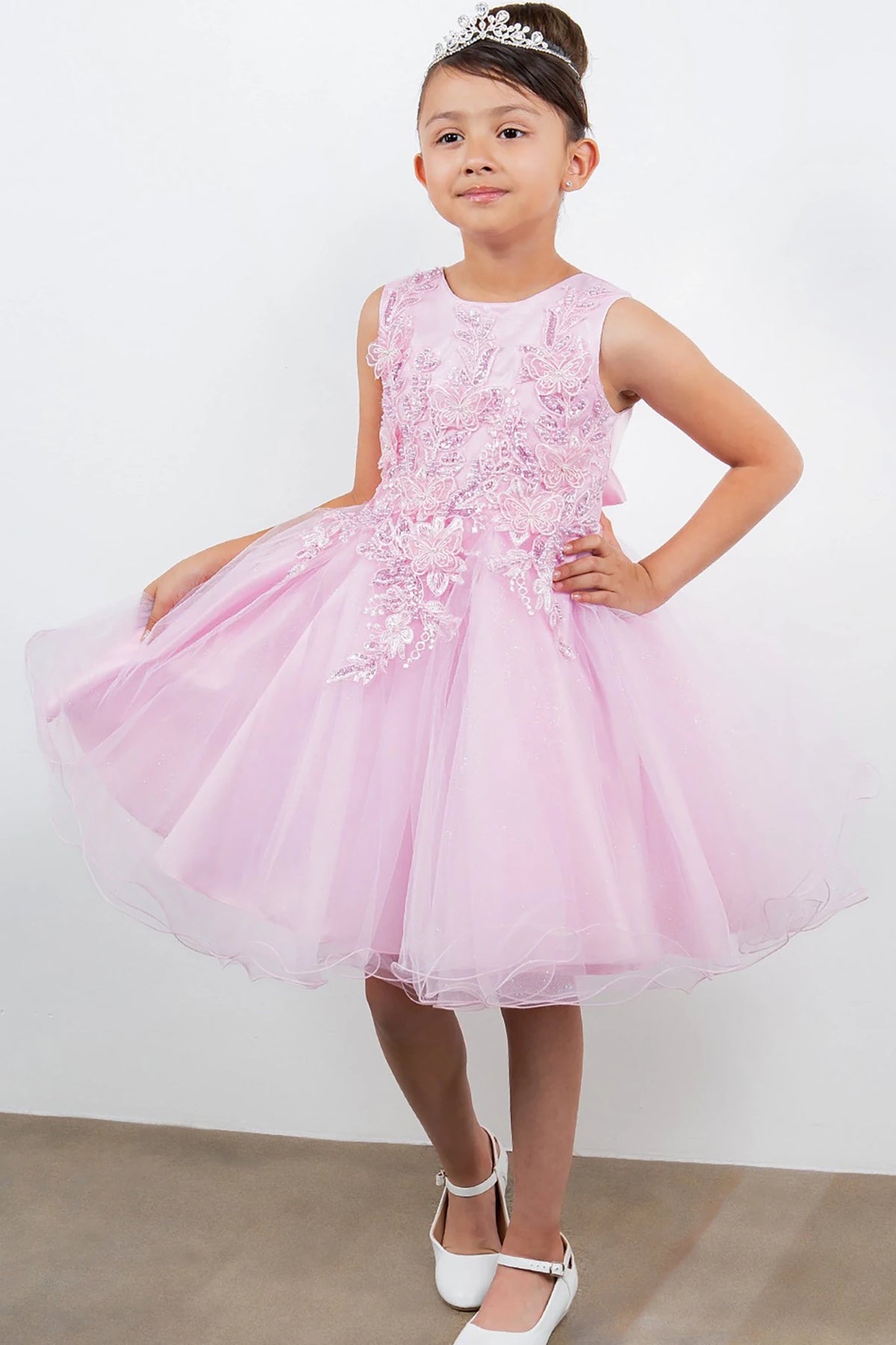 A pink flower girl dress with floral details.