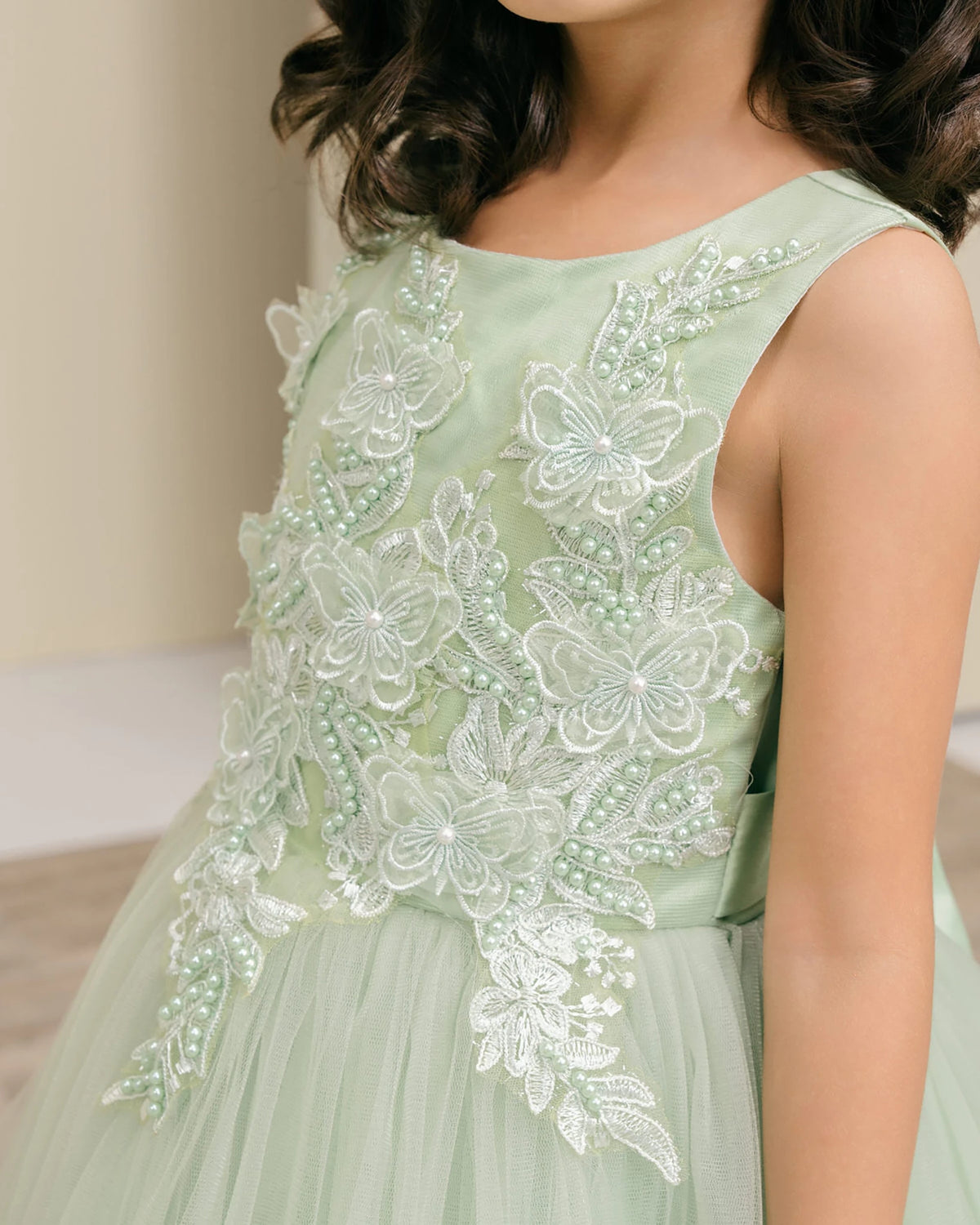 Sage flower girl dress with butterfly lace details.