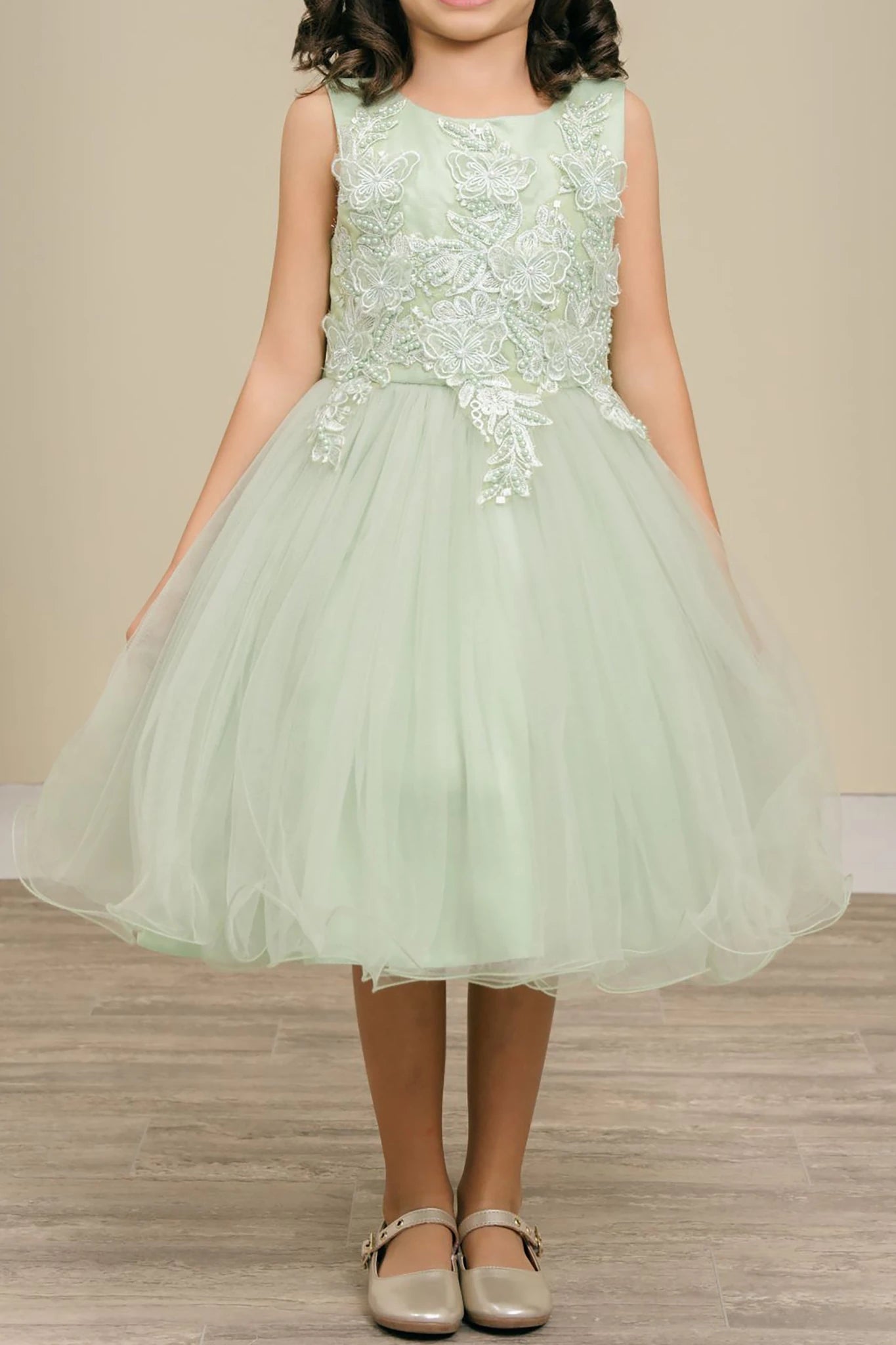 sage dress with floral lace top and tulle skirt on a neutral background