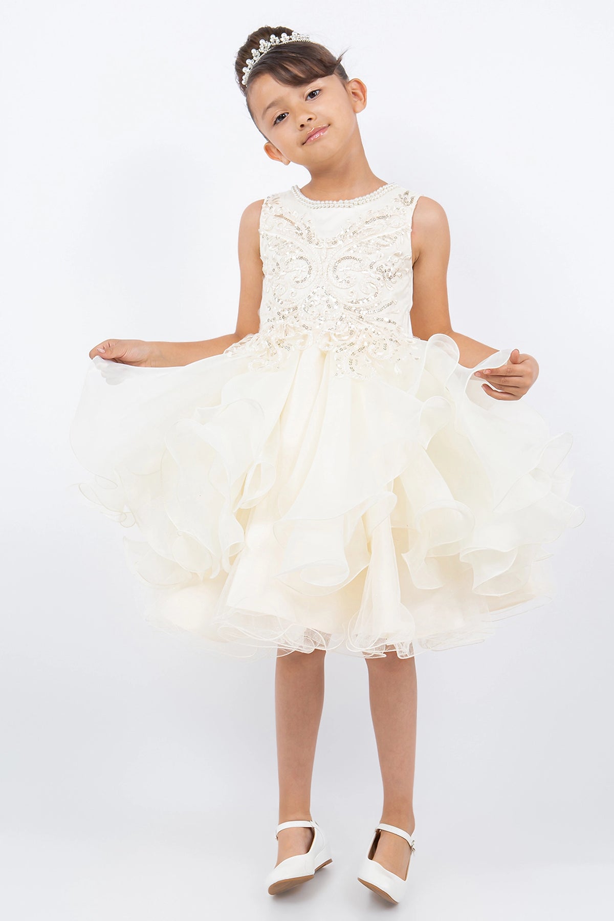 Ivory flower girl dress features beaded bodice above a ruffled tulle skirt.