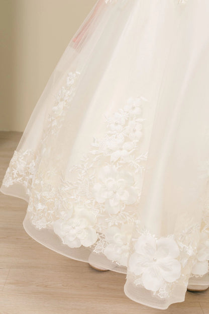 Notice the lace-trimmed skirt with raised floral appliques on this Ivory flower girl dress.
