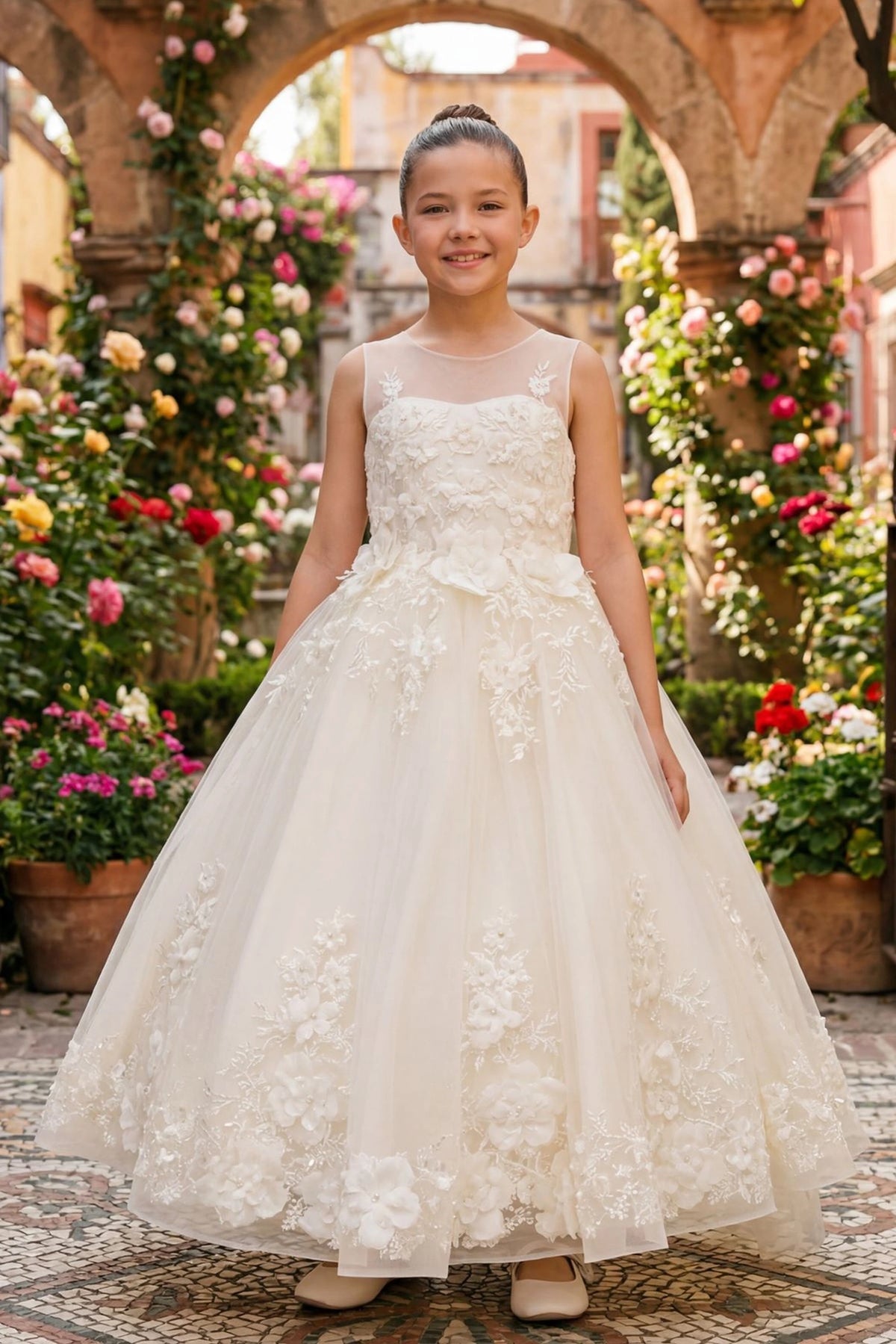 Ivory flower girl dress features raised flowers cascading into the lace-edged skirt.