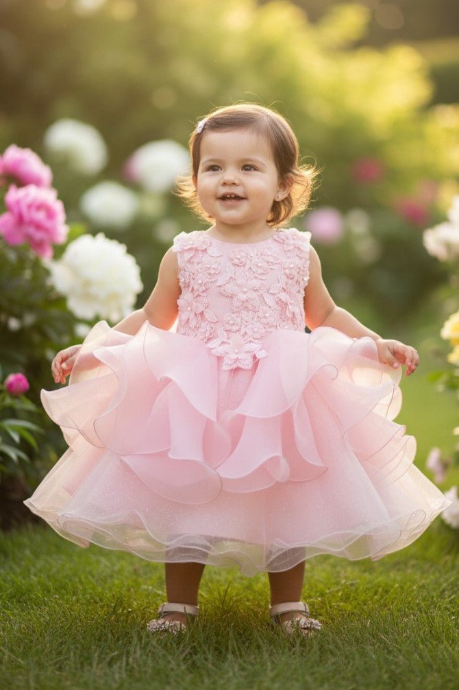 Blush flower girl Dress Front View With Layered Skirt And Oversized Bow Detail.