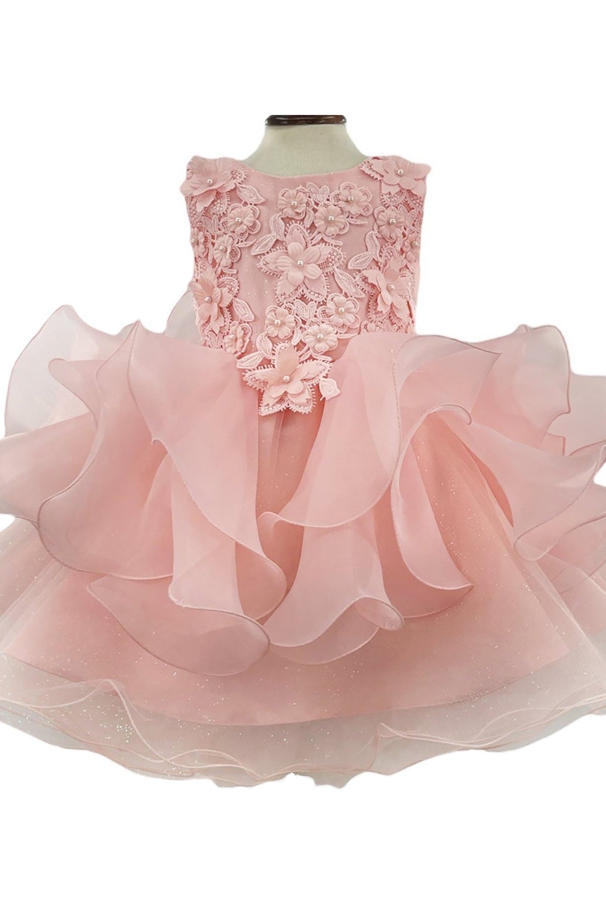 Front-facing in blush tulle birthday flower girl dress with pearl embellishments and sequin floral detailing on bodice and skirt.