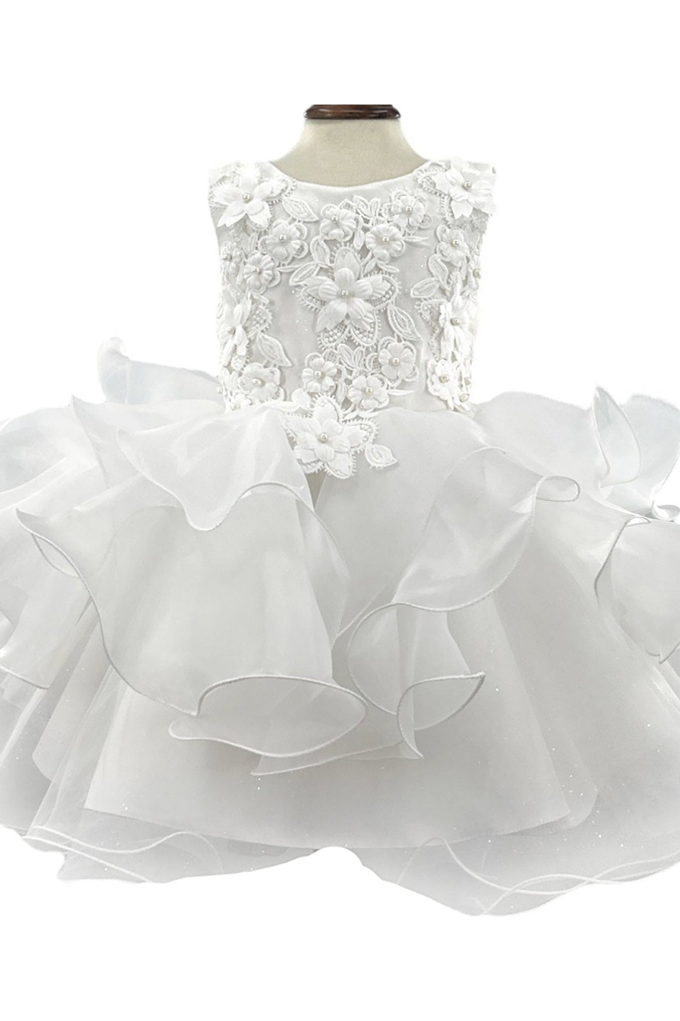 White flower girl dress with lace top and ruffled skirt.