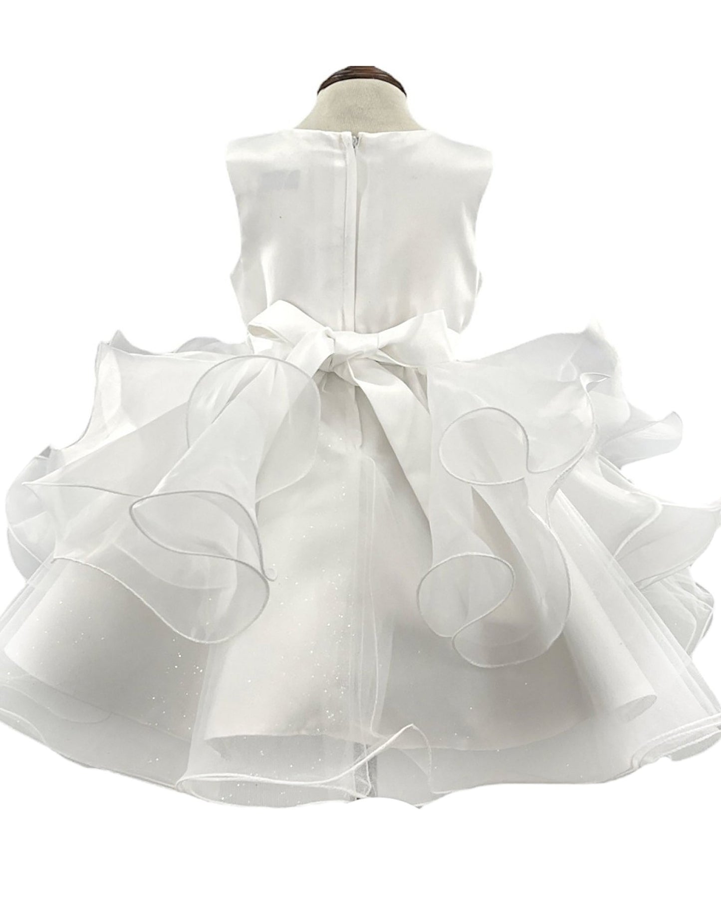 White flower girl dress with ruffled layers.
