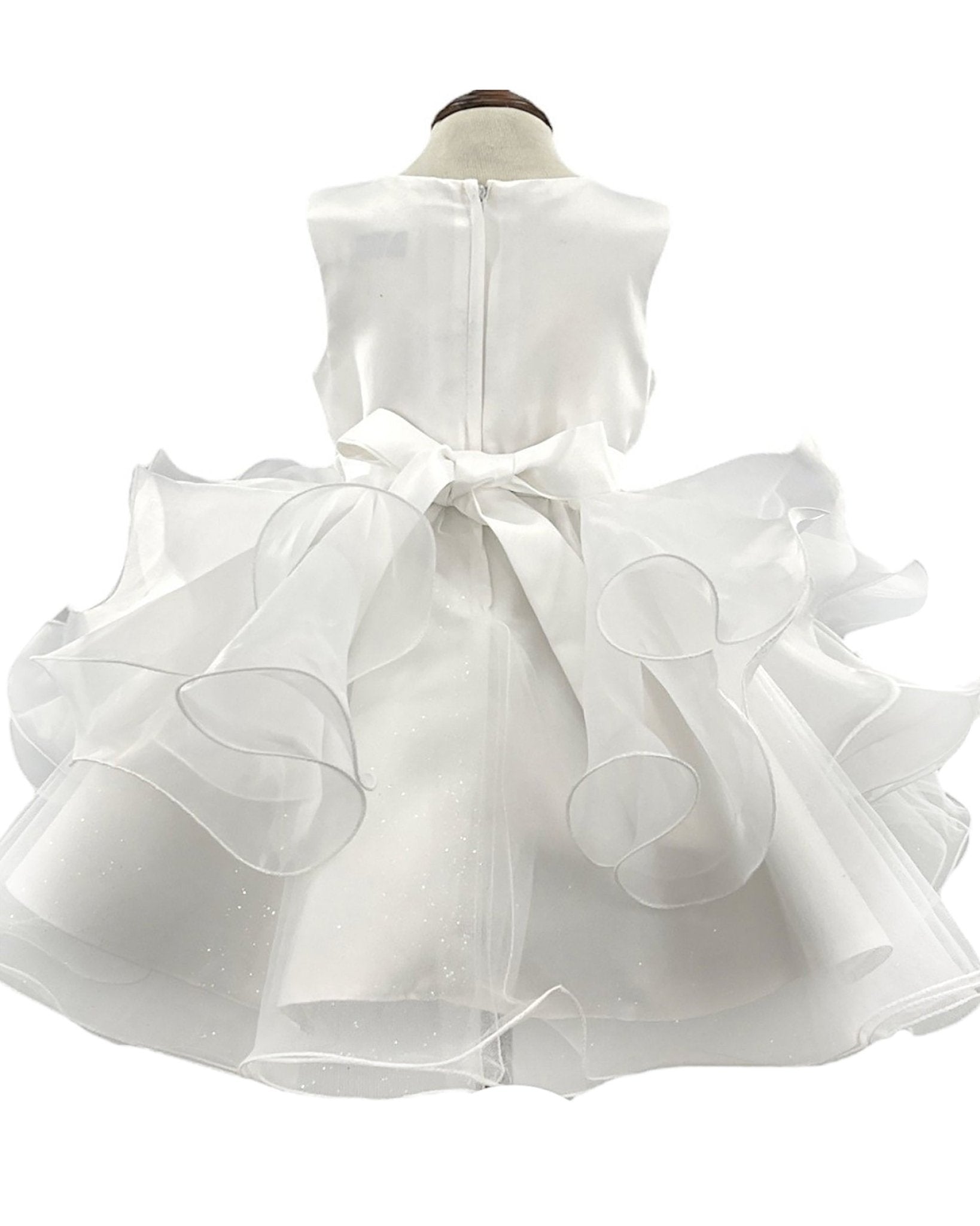 White flower girl dress with ruffled layers.