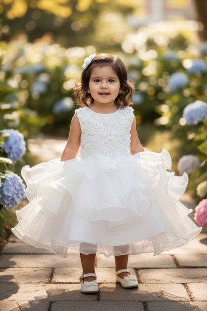 Kid Wearing White Flower Girl Dress Front View With Layered Skirt And Oversized Bow Detail