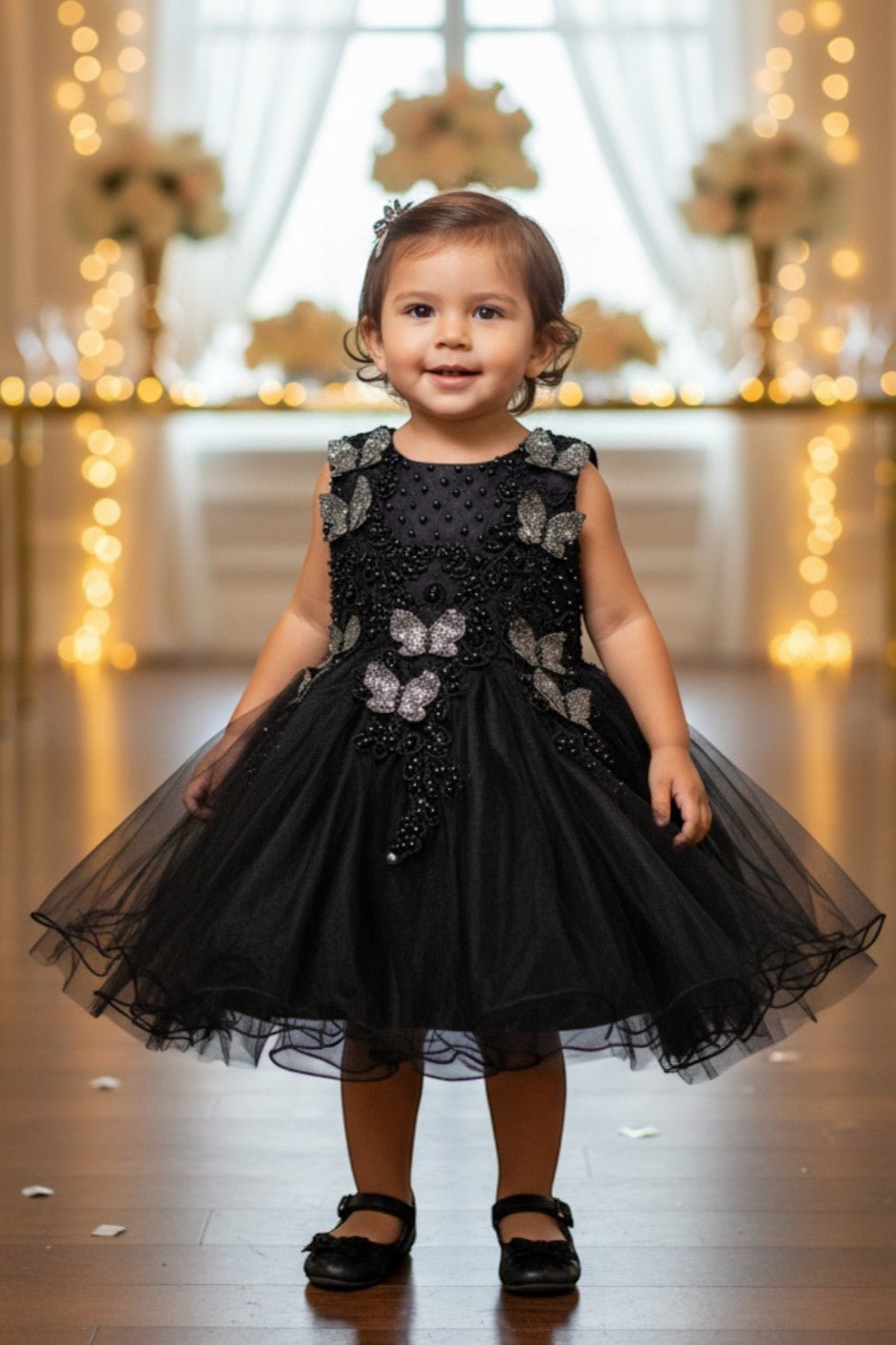 Black flower girl Dress Front View With Layered Skirt And Oversized Bow Detail.
