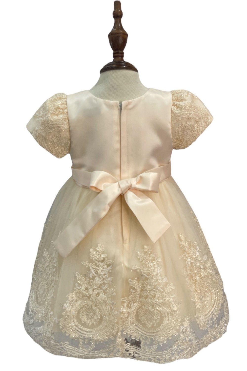 Cream dress back view highlighting full skirt and elegant silhouette