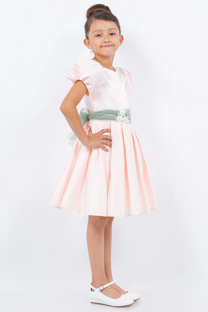 Featuring puff sleeves above a pleated skirt on the Blush flower girl dress.