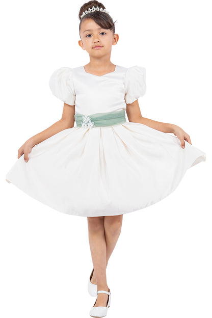 Ivory flower girl dress features puff sleeves and pleated satin skirt.