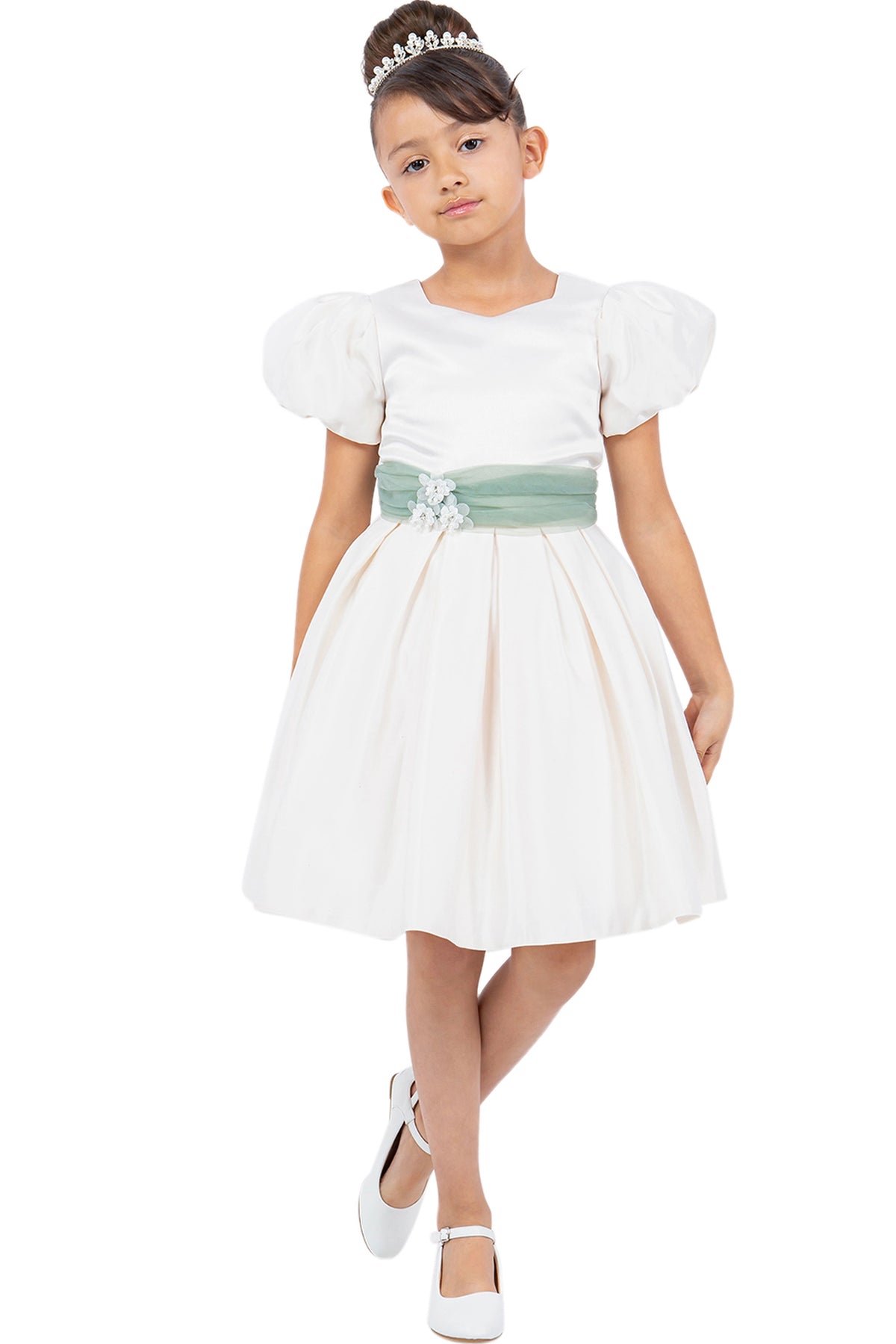 Details of the Ivory flower girl dress include pleated skirt with a contrasting waist sash.